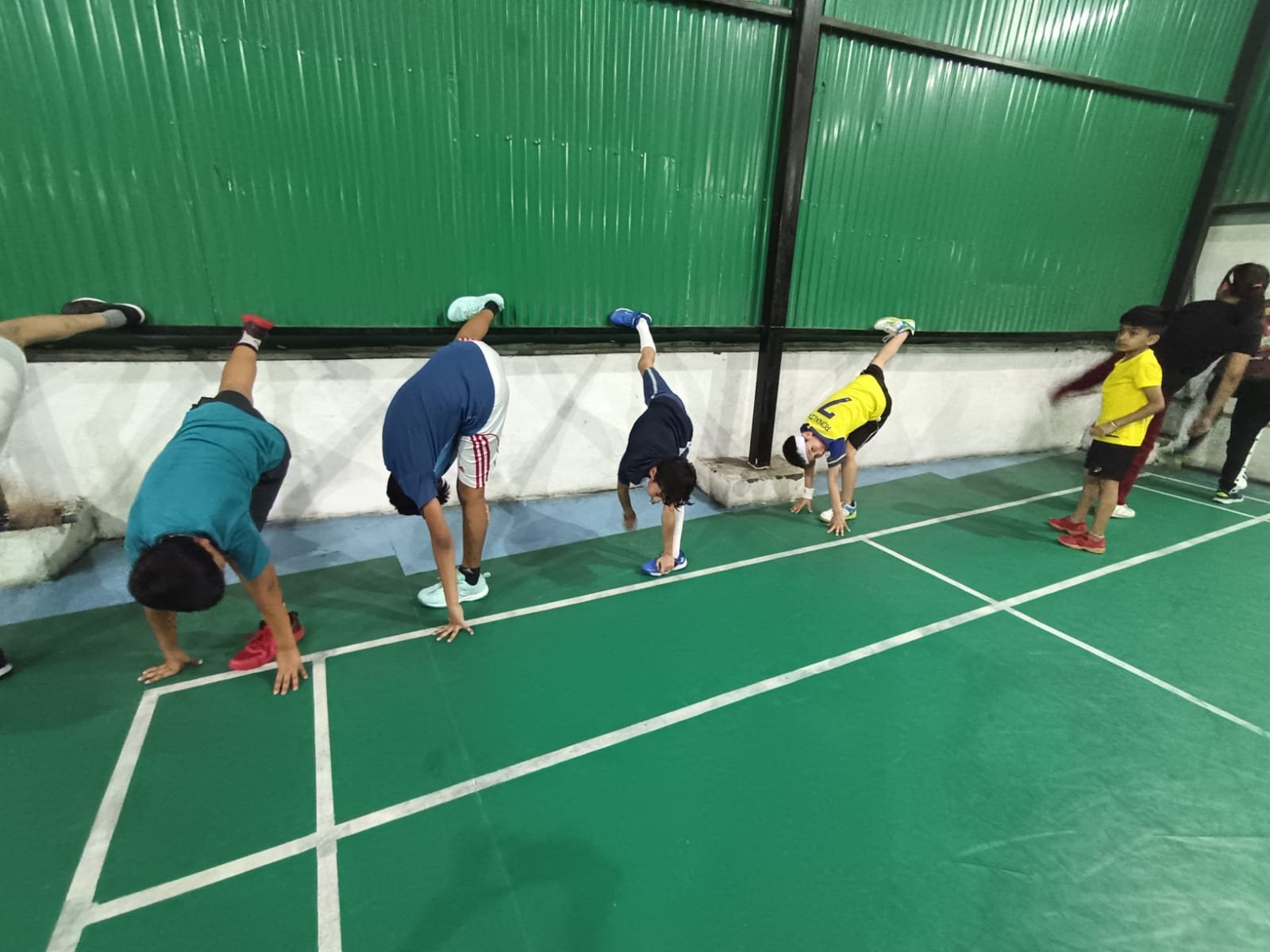 Wall-supported stretching before drills